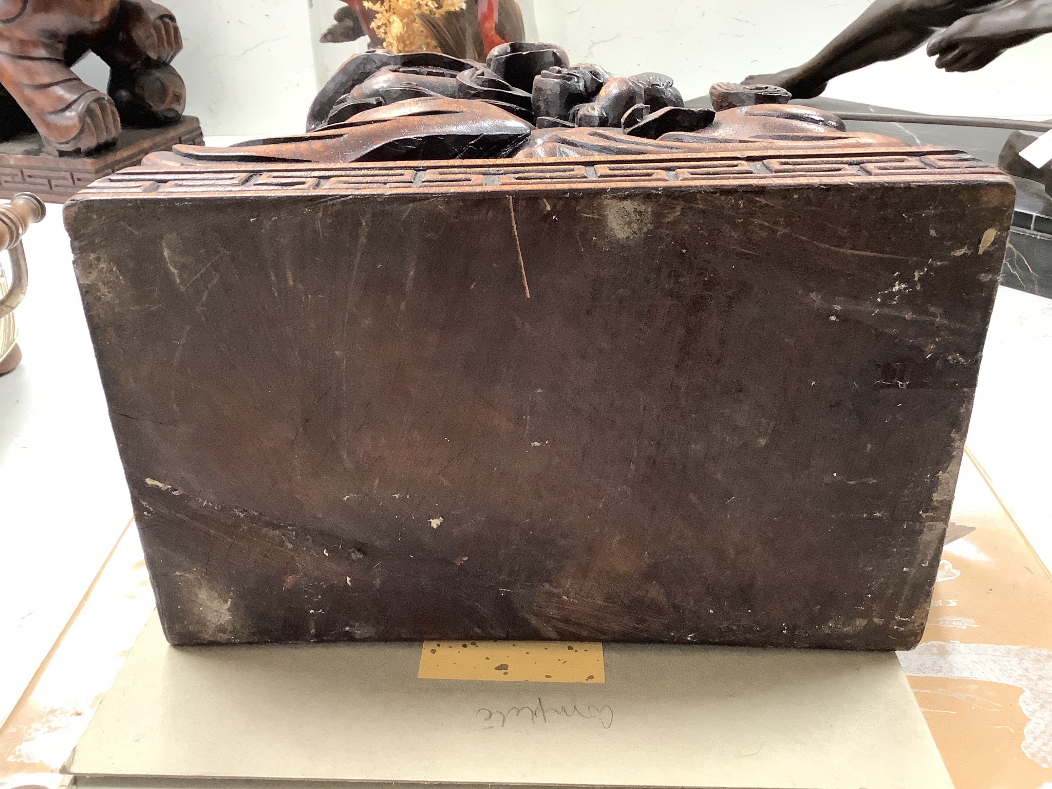 A pair of Chinese carved hardwood Buddhist lions, width 26cm height 37cm